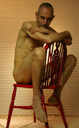 model Grayglove art nude modelling photo. nude male in red chair.