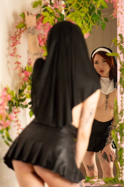 photographer Tom Bombadil glamour modelling photo. sister eva checks her outfit in the mirror before heading out of the convent head piece  check white bib  check skirt  check as she departs it doesnt even occur to her that something is missing what can it be.